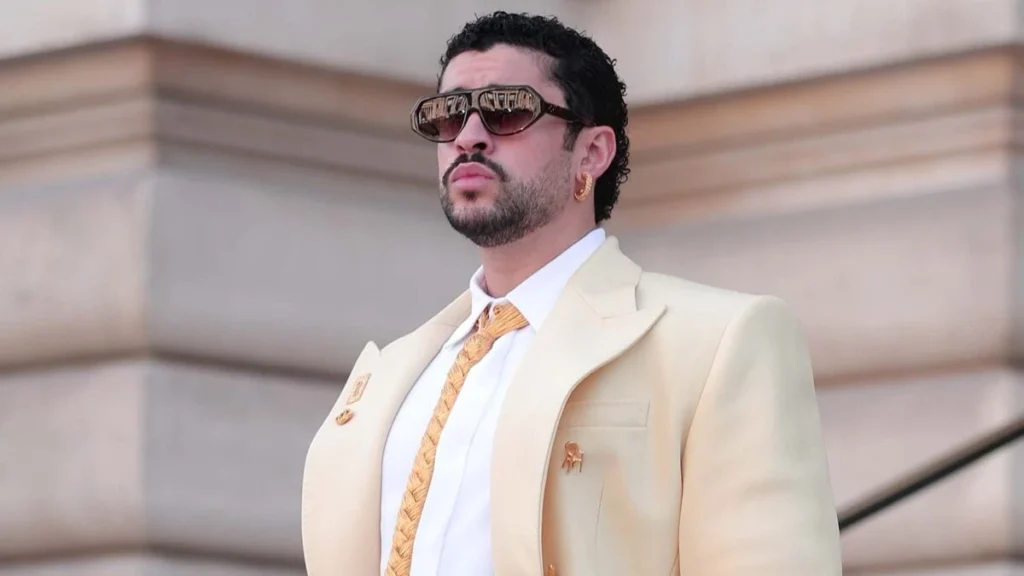 Bad Bunny in a cream suit and sunglasses